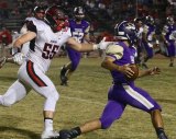 Lemoore's Noah Gonzalez looks for an opening as Hanford's Mason Brosseau gives chase Friday night in Tiger Stadium. The Tigers ended their season with a 42-6 loss to Hanford.